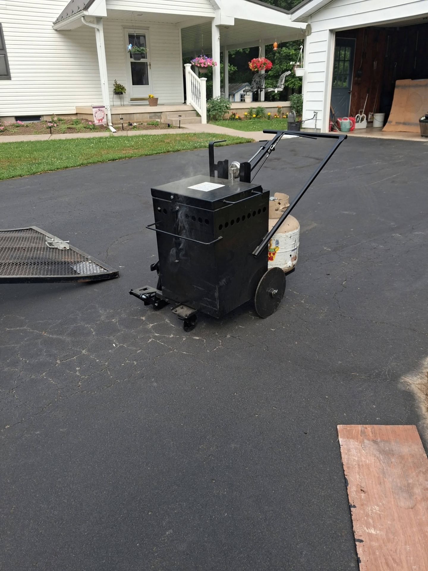 Sealcoating equipment on a freshly finished asphalt driveway in Central Pennsylvania